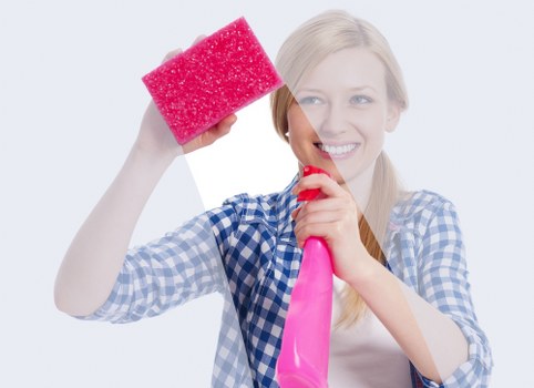 Technician performing professional carpet cleaning in an office